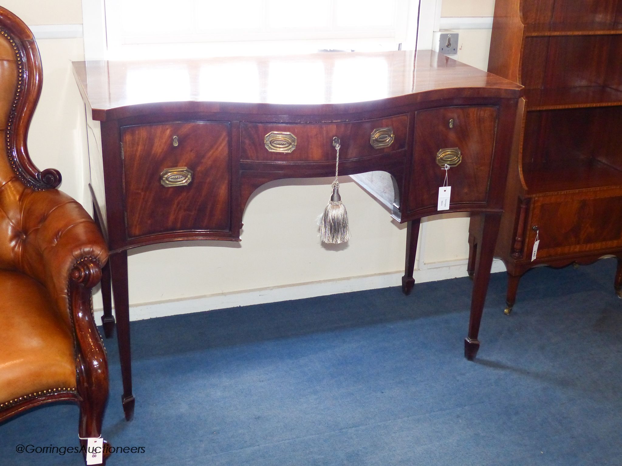 A George III and later mahogany serpentine fronted sideboard, 114.5 cm long, 61 cm deep, 87.5 cm high